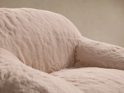 Front view of the beige Snugg Faux Fur Kids Chair, a soft, rounded chair upholstered in cozy faux fur.