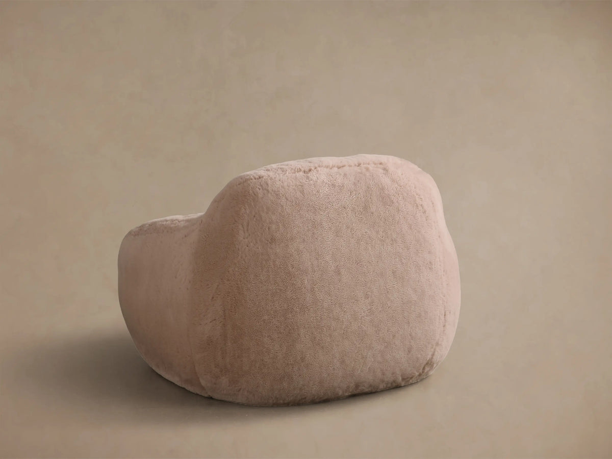 Close-up of the light beige faux fur of the Snugg Faux Fur Kids Chair, highlighting its soft, plush fibers.