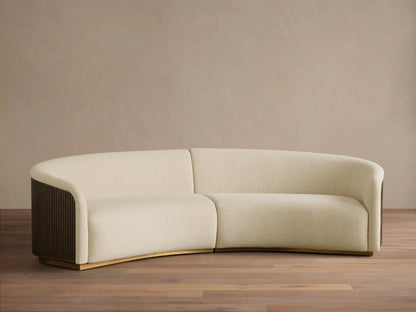 Front view of the cream Finnley Two-Piece Curved Sectional with dark brown slatted sides and a light wood base.