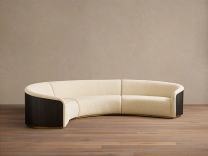 Front view of the cream Finnley Three-Piece Curved Sectional with dark ebony ribbed wood sides and a honey wood base.