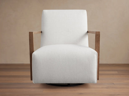 Walsh Glider with a white cushioned seat and back, featuring wooden armrests. Set on a circular swivel base, positioned on a wooden floor.