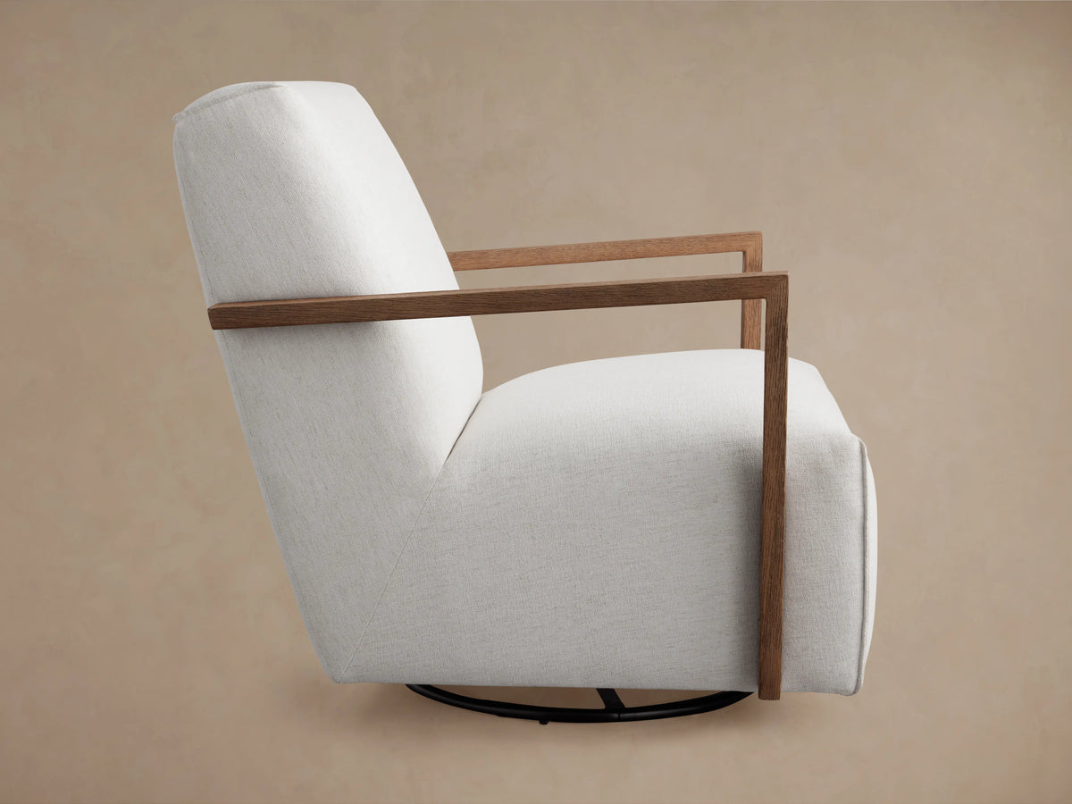 Walsh Glider close-up showing light fabric upholstery and smooth wooden armrests on a neutral background.