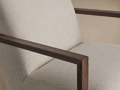 Walsh Glider chair with beige fabric upholstery, wooden armrests, and a round base for swiveling, on a wooden floor.