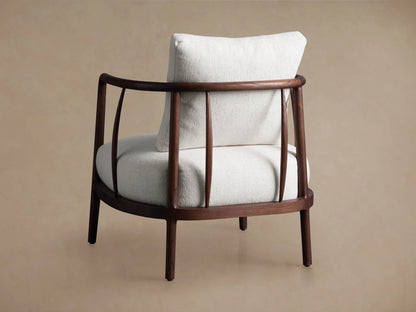 Griggs Chair with curved mahogany frame, rich tone finish, and plush light-colored upholstery, on a neutral background.