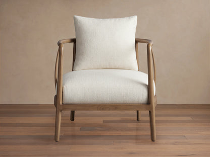 Griggs Chair with a solid mahogany and sungkai wood frame in rich tones, features light-colored plush upholstery and generous cushioning.