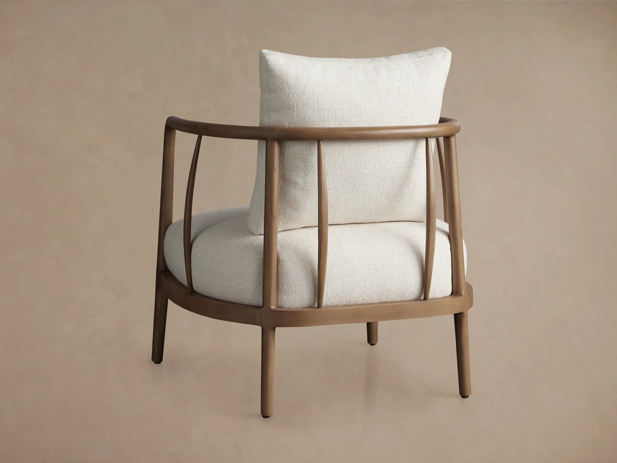 Griggs Chair in side view, showcasing solid mahogany frame in rich tones and plush white upholstery with a padded cushion.