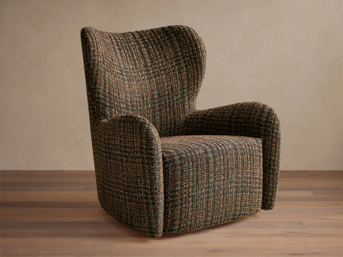 Gemma Swivel Chair with a textured, tweed-like fabric in earthy tones; curved backrest and armrests on a wooden floor.