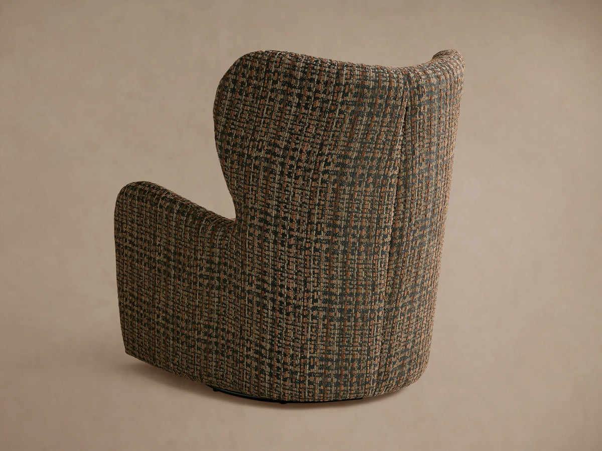 Gemma Swivel Chair with textured multicolored fabric, angled view showing armrest and seat cushion detailing in a warm, patterned weave.