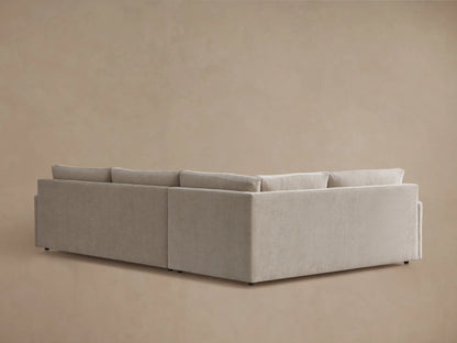 Kipton Two-Piece Sectional in beige fabric showing a plush seat cushion and armrest. The fabric has a soft, textured appearance.