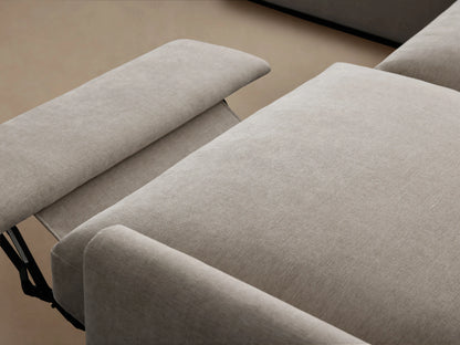 Kipton Four-Piece Motion Sectional in light beige fabric, featuring slim arms and a curved design, displayed on a wooden floor.