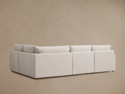 Kipton Four-Piece Motion Sectional in light gray fabric, showing extended footrest and reclining feature. Slim arm design with sleek finish.