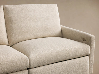 Kipton Four-Piece Motion Modular Sofa in beige fabric, featuring a textured surface and a sleek silver two-button control on the armrest.