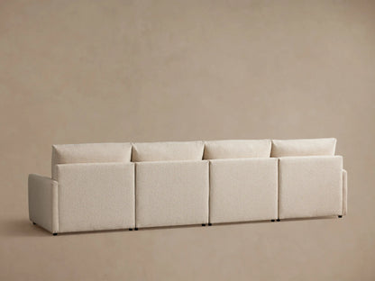 Kipton Four-Piece Motion Modular Sofa in a light beige fabric, featuring sleek, slim arms. The seat and backrest appear plush and cushioned.