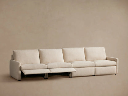 Kipton Four-Piece Motion Modular Sofa shown from the back, featuring light beige upholstery and slim arm design.