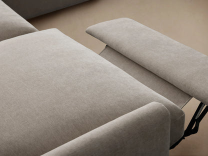 Kipton Four-Piece Motion Sectional in a light beige fabric, forming an L-shape. Slim arms, plush cushions on hardwood floor.