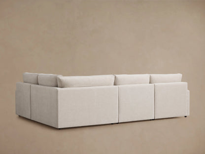 Kipton Four-Piece Motion Sectional with a smooth, light grey fabric. Close-up shows partially reclined footrest, sleek design.