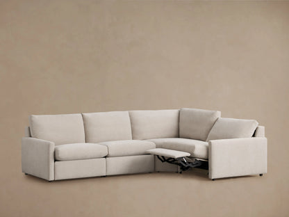 Kipton Four-Piece Motion Sectional in beige fabric. Left section partially reclined, showcasing footrests. Slim arms, plush backrests.