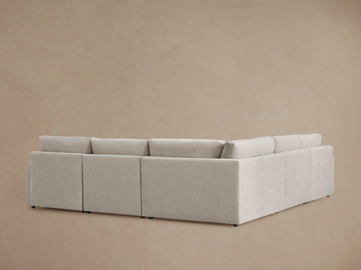 Kipton Five-Piece Motion Corner Sectional in beige fabric, partially reclined with visible footrest; smooth, cushioned surface.