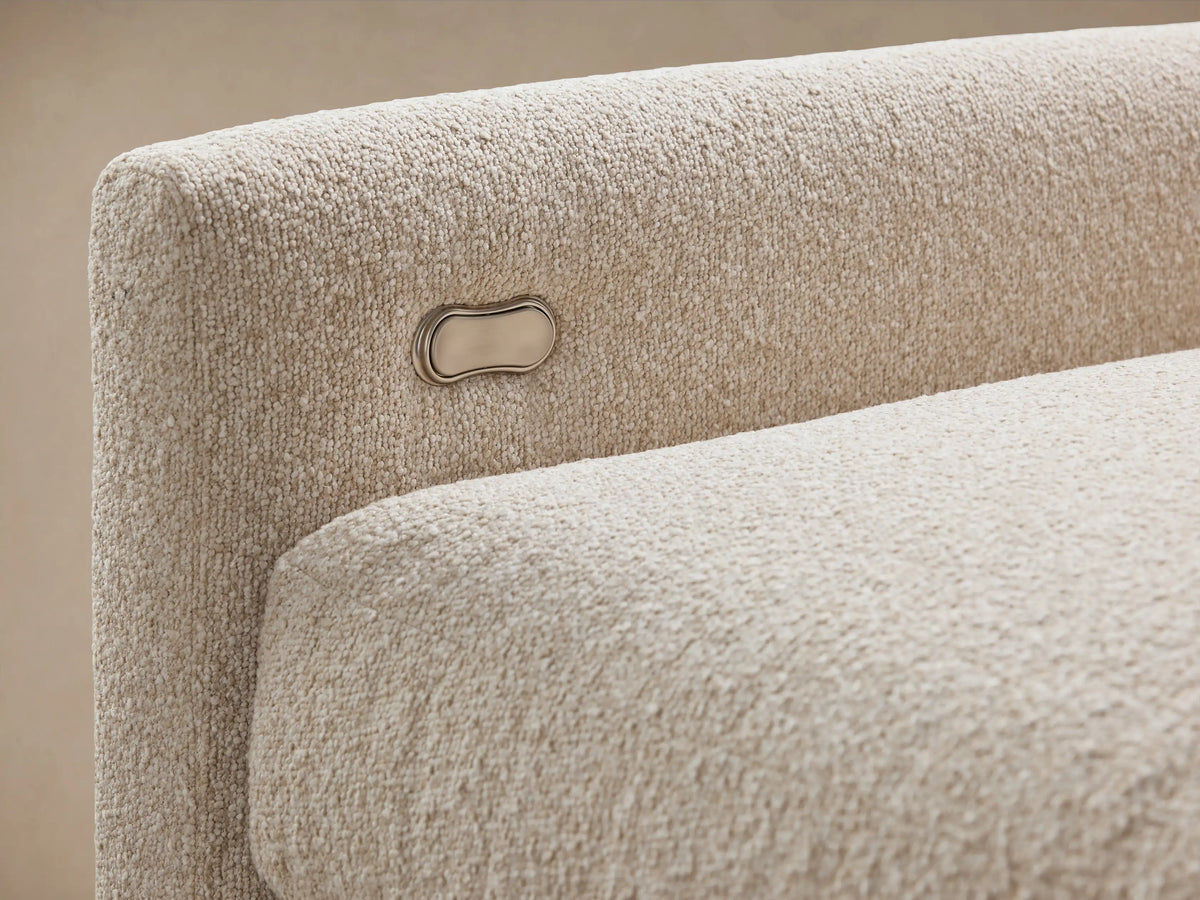 Kipton Six-Piece Motion Sectional in light beige fabric, L-shaped with six seats, slim arms, set on wooden floor.