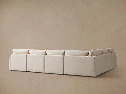 Kipton Six-Piece Motion Sectional in beige fabric with slim arms and plush cushions, arranged in an L-shape on a neutral background.