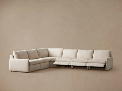 Kipton Six-Piece Motion Sectional in light beige fabric, rear view. Displays cushioned backrests and sleek design on a neutral background.