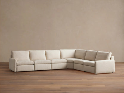 Elevated view of a beige Kipton Slim Arm Six-Piece Motion Sectional in an L-shape, with one reclined footrest.