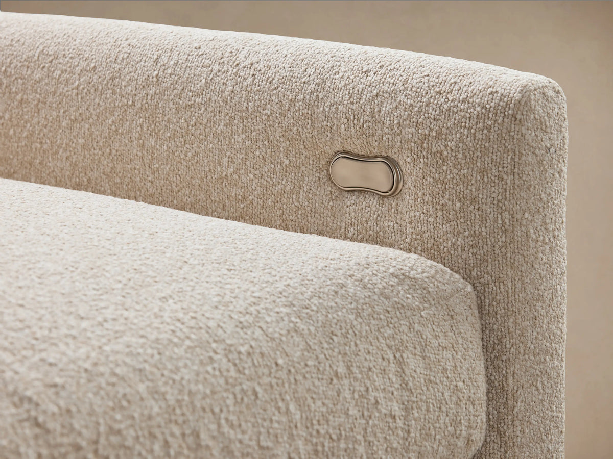 Kipton Six-Piece Motion Sectional in beige fabric, L-shaped with slim arms, set against a neutral-toned wall and wooden floor.