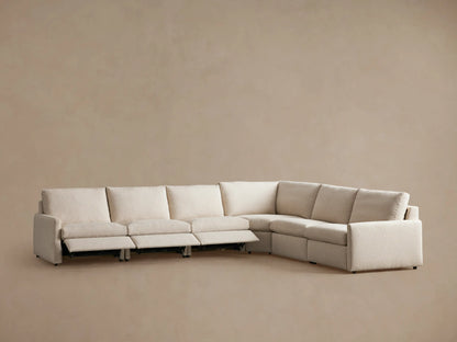 Alt text: Kipton Six-Piece Motion Sectional in beige fabric, shown from a rear angle. Features slim arms and cushioned backrest.