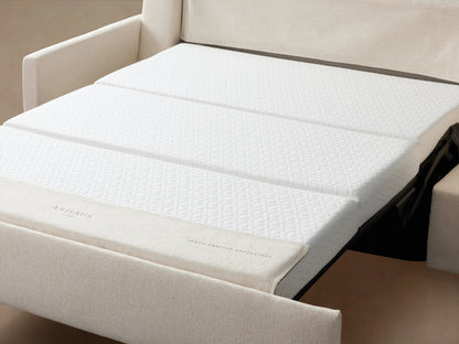Kipton Luxury Sleeper Sofa in cream fabric with straight arms, plush seat and back cushions on wooden floor, against a beige background.