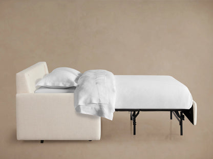 Back view of the Kipton Luxury Sleeper Sofa in a soft cream fabric, featuring a sleek design and plush back cushions.
