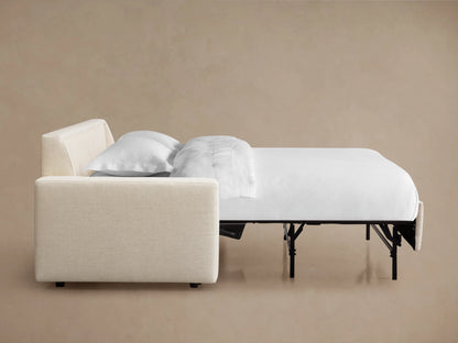 Kipton Wide Arm Luxury Sleeper Sofa in beige, shown from the side with mattress partially pulled out, against a neutral background.