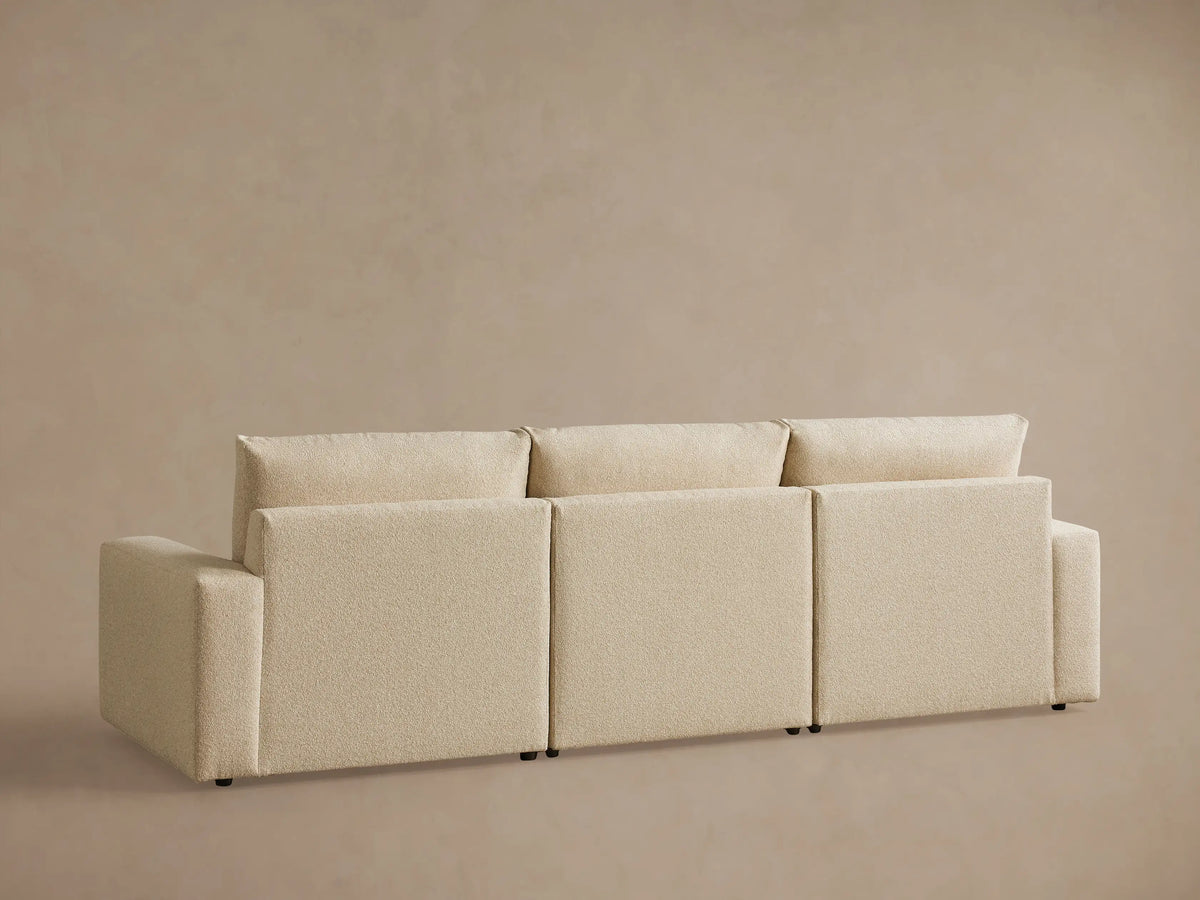 Kipton Wide Arm Three-Piece Motion Modular Sofa in beige fabric, showing wide arm, plush cushions, and textured upholstery.