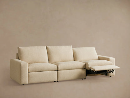 Kipton Wide Arm Three-Piece Motion Modular Sofa in beige fabric, two seats reclined with extended footrests, wide arms, set against a neutral background.