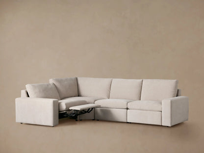 Light beige Kipton Wide Arm Four-Piece Motion Sectional, L-shaped with two extended footrests.