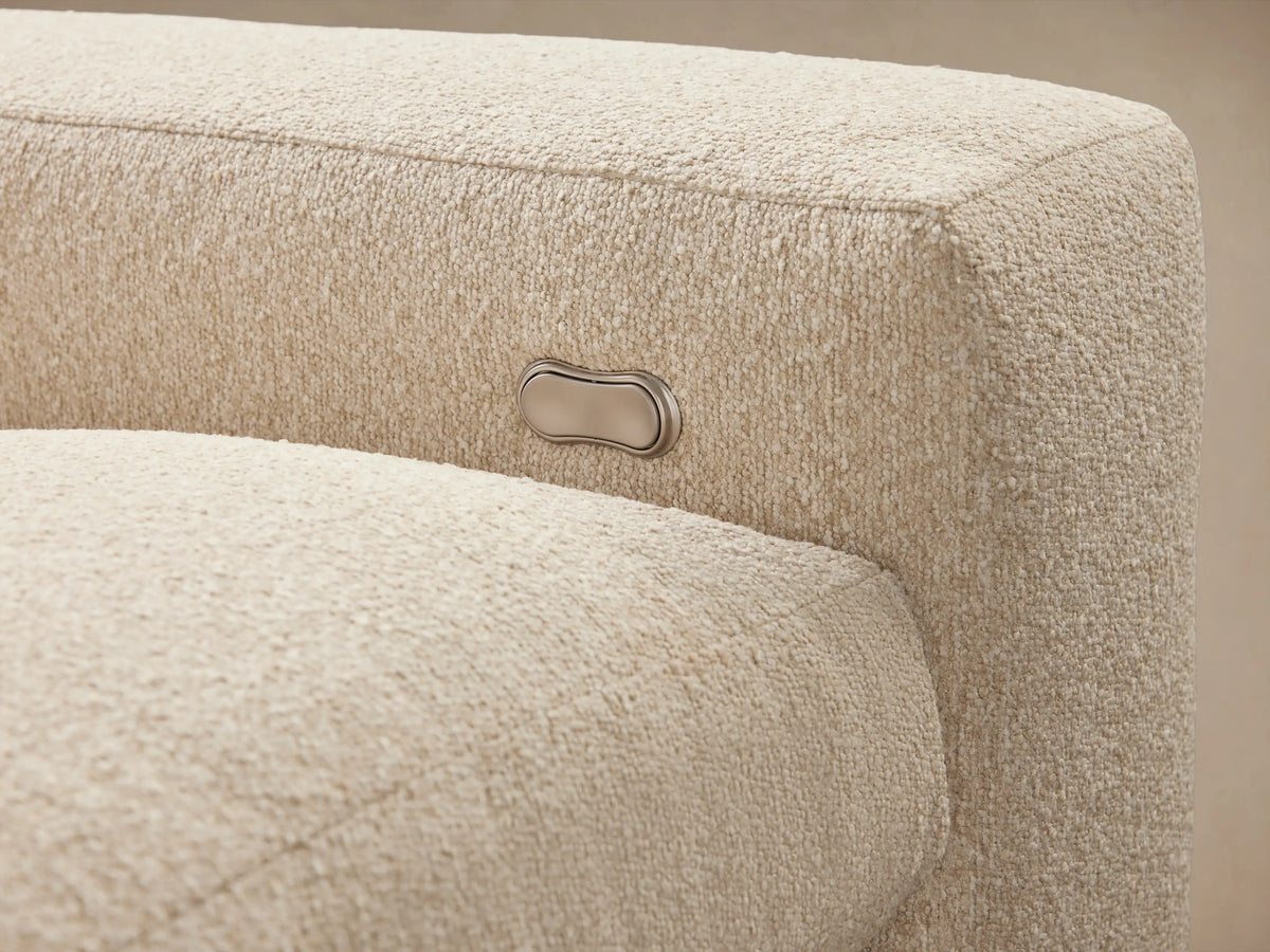Kipton Wide Arm Four-Piece Motion Modular Sofa in beige fabric, with wide arms, on wood floor against neutral wall.