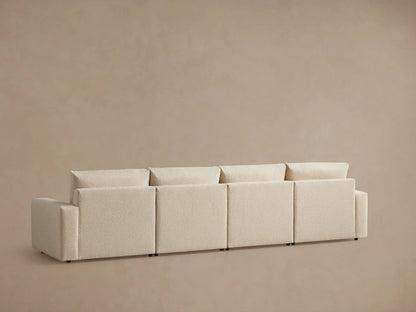 Alt text: Kipton Wide Arm Four-Piece Motion Modular Sofa in textured beige fabric, featuring wide padded armrests and plush cushions, against a neutral background.