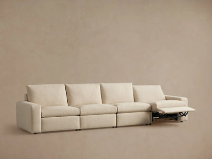 Kipton Wide Arm Four-Piece Motion Modular Sofa in neutral fabric, showing back view with wide arms and four cushion sections.