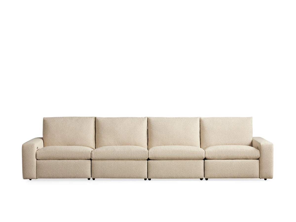 Kipton Wide Arm Sofa, four-piece, beige fabric, wide arms, left segment reclined with footrest elevated. Neutral background.