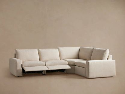 Rear view of the Kipton Wide Arm Four-Piece Motion Sectional in beige fabric, showing wide arms and three backrests on a plain background.