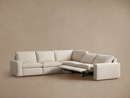 Kipton Wide Arm Five-Piece Motion Corner Sectional in beige fabric, L-shaped with a reclining section. Wide arms, supportive backrests.