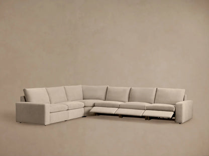 Kipton Wide Arm Six Piece Motion Sectional in beige fabric; L-shaped, wide arms, plush cushions; set in a modern room.