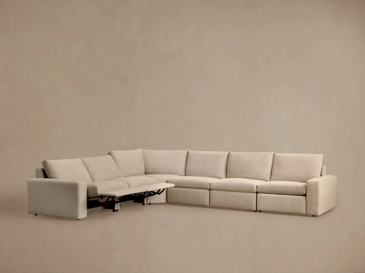 Kipton Wide Arm sectional showing a close-up of the beige fabric armrest with a sleek, metallic two-button motion control.