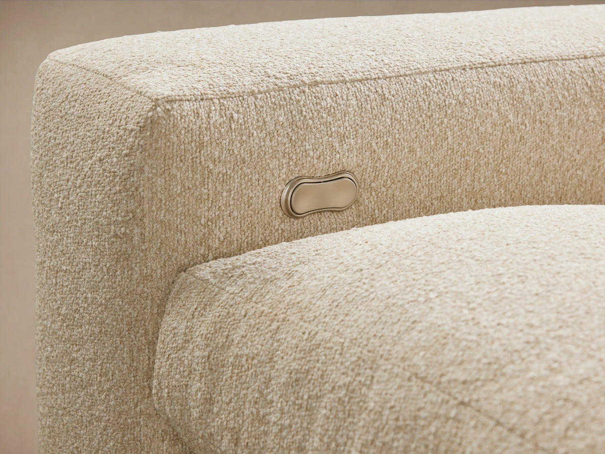 Kipton Wide Arm Six Piece Motion Sectional in beige fabric, L-shaped configuration. Wide arms, deep seats, set on wooden floor, against neutral wall.