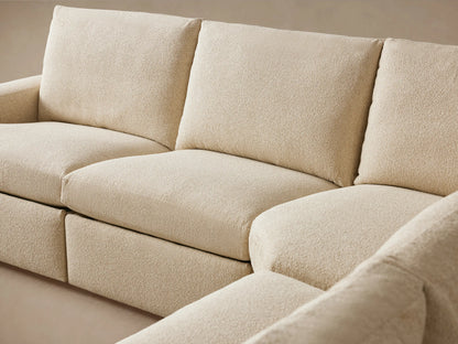 Beige fabric arm of the Kipton Wide Arm Six Piece Motion Sectional with visible two-button motion control on the side.