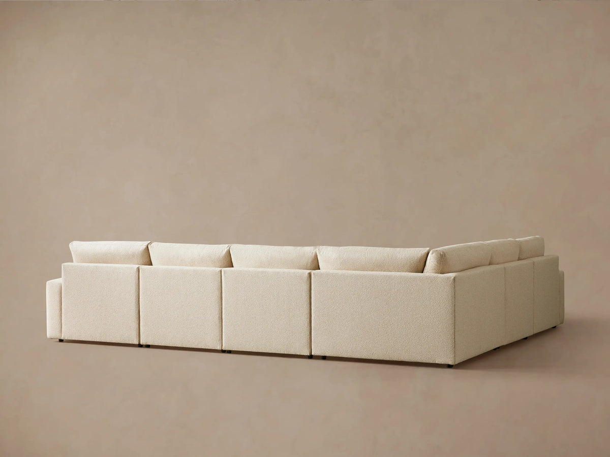 Kipton Wide Arm Six Piece Motion Sectional in beige fabric, showing three deep seats and back cushions, with wide arms.