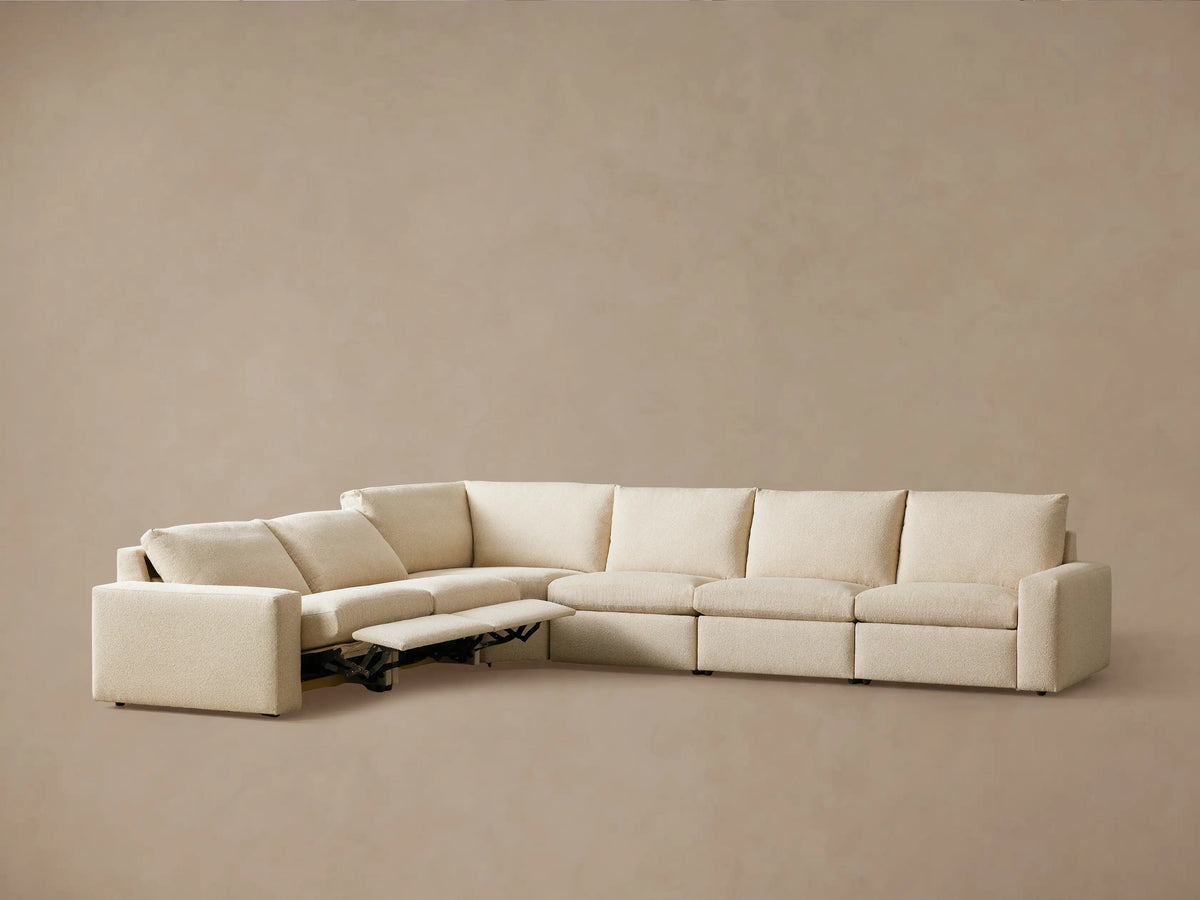 Kipton Wide Arm Six Piece Motion Sectional in beige fabric, L-shaped with wide arms, two reclined footrests, shown against a neutral background.