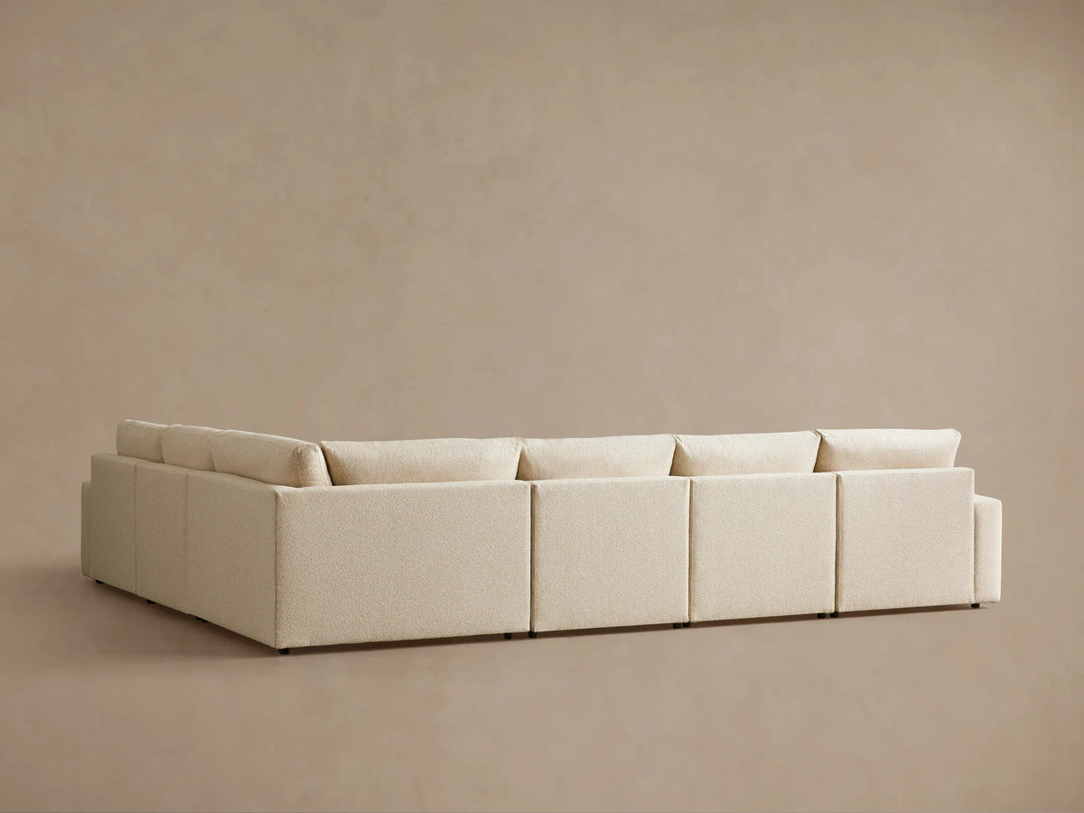 Kipton Wide Arm Six Piece Motion Sectional in beige fabric, showcasing wide arms and plush cushions, arranged in a corner setting.