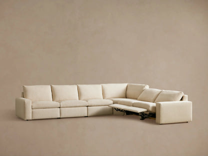 The Kipton Wide Arm Six Piece Motion Sectional shown from the back, featuring light beige upholstery and blocky, wide arms.