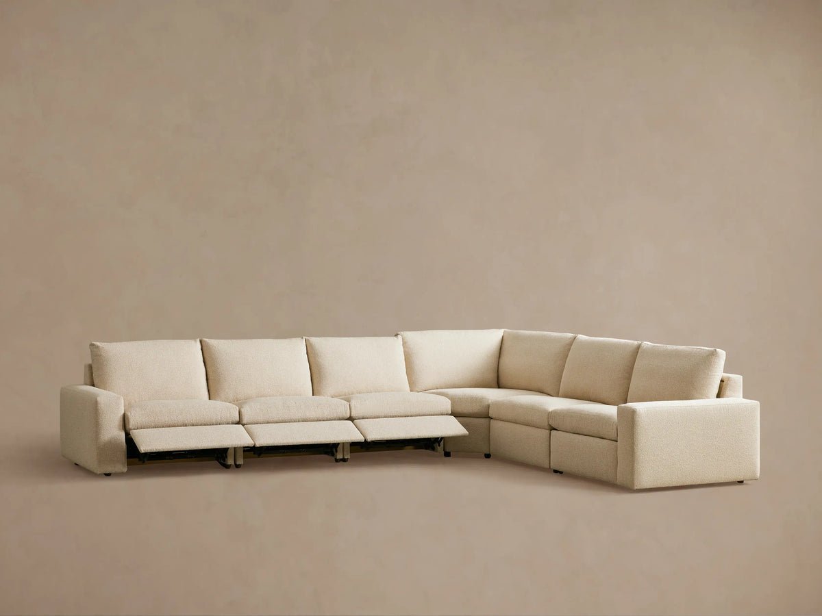Kipton Wide Arm Six Piece Motion Sectional in beige fabric, wide armrests, one seat reclined, on a neutral background.