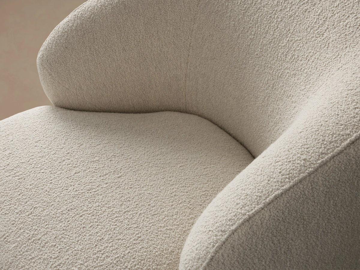 Close-up of Alonzo Swivel Chair, showing its textured, off-white boucle fabric on the curved backrest and seat.